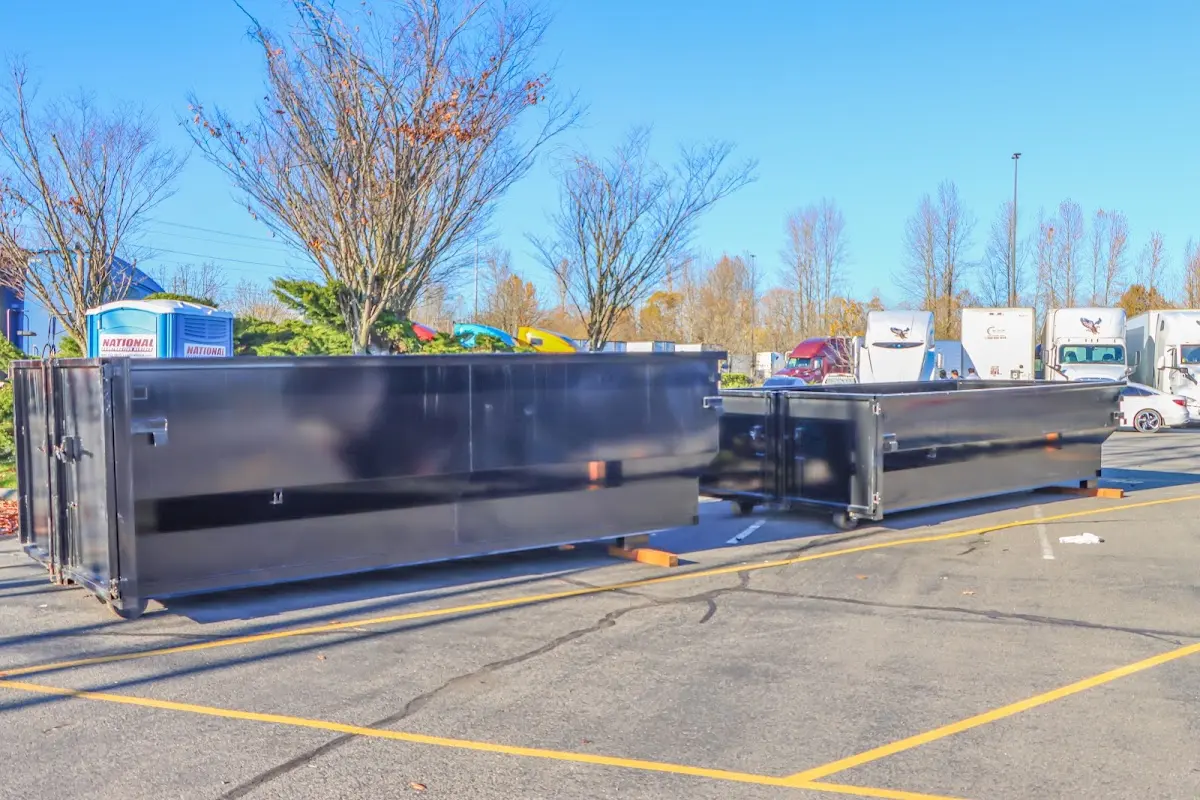 Professional dumpster rental service with roll-off container on residential driveway in Daly City